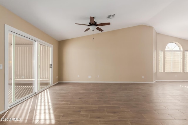 empty room featuring lofted ceiling, ceiling fan, and hardwood / wood-style floors