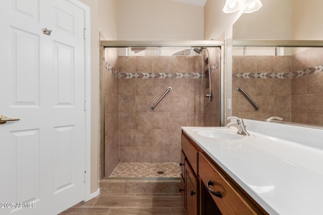 bathroom featuring an enclosed shower and vanity