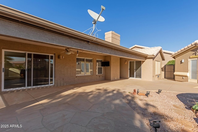 rear view of property featuring a patio area and ceiling fan