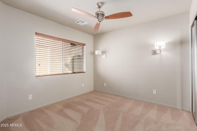 carpeted spare room featuring ceiling fan