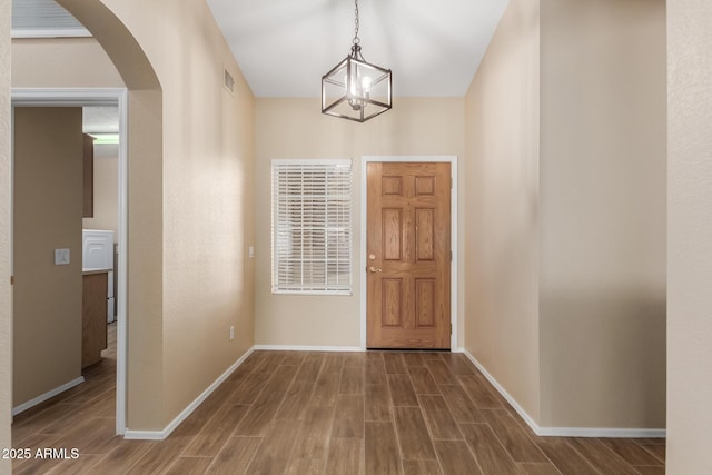 foyer entrance with an inviting chandelier