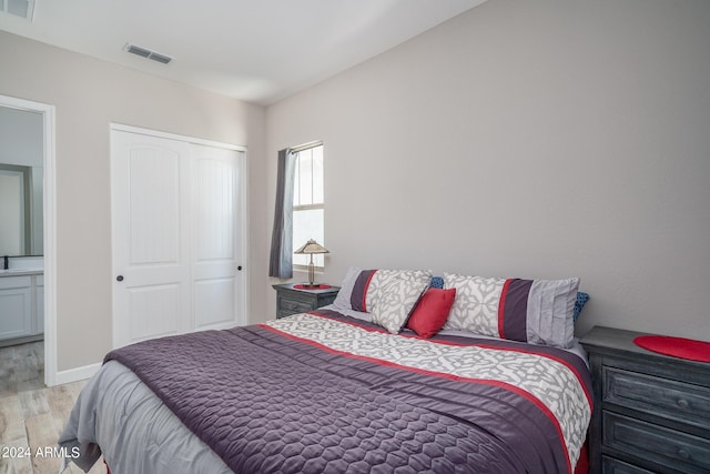 bedroom featuring a closet and light wood-type flooring