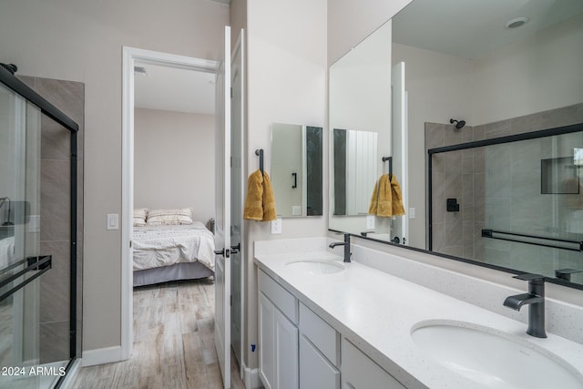 bathroom featuring walk in shower, vanity, and hardwood / wood-style floors