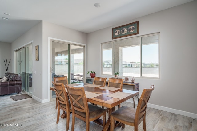 dining space with a healthy amount of sunlight and light hardwood / wood-style floors