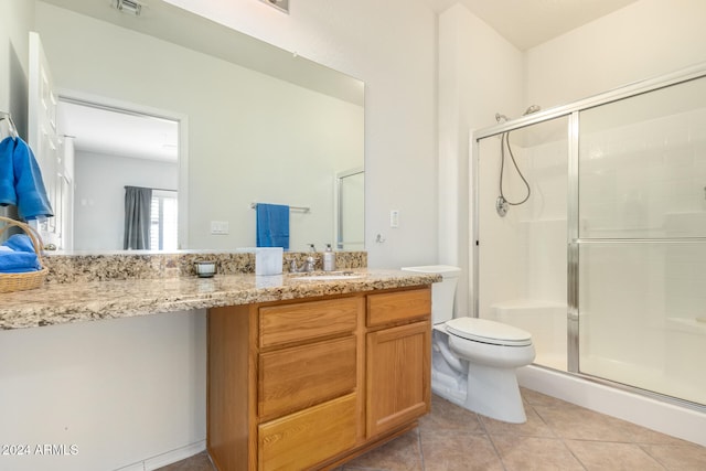 bathroom featuring vanity, toilet, tile patterned floors, and walk in shower