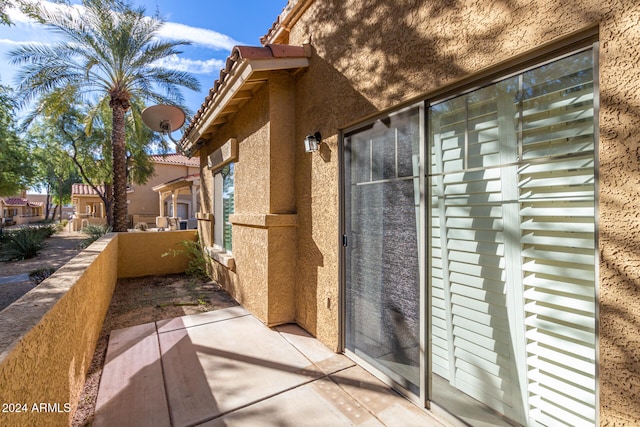 view of side of home with a patio area