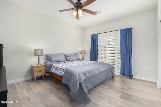 bedroom with light hardwood / wood-style floors and ceiling fan