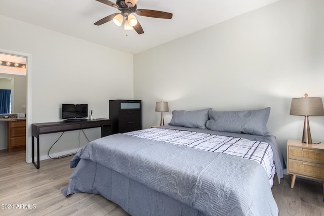 bedroom with ensuite bath, light wood-type flooring, and ceiling fan