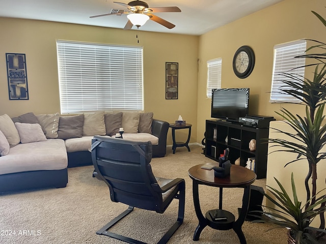 carpeted living room with baseboards and ceiling fan