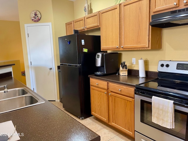 kitchen with black refrigerator, sink, stainless steel electric range, and light tile patterned floors