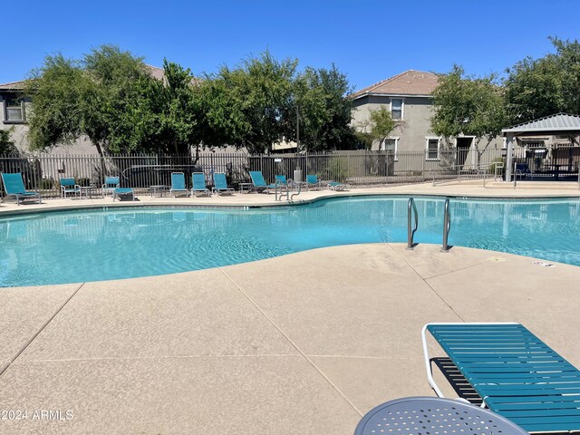 view of swimming pool with a patio and a gazebo