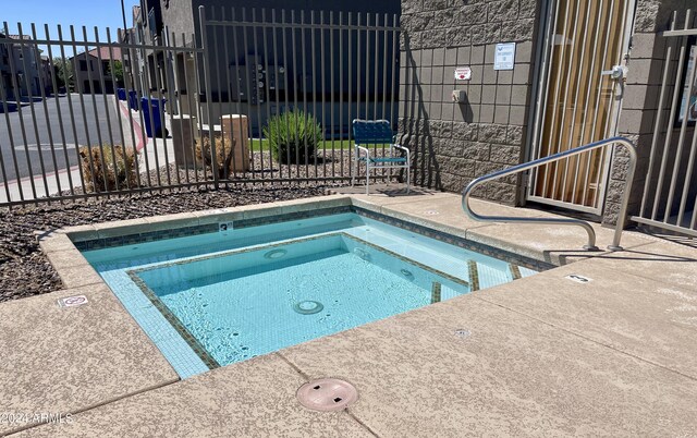 view of swimming pool featuring a community hot tub