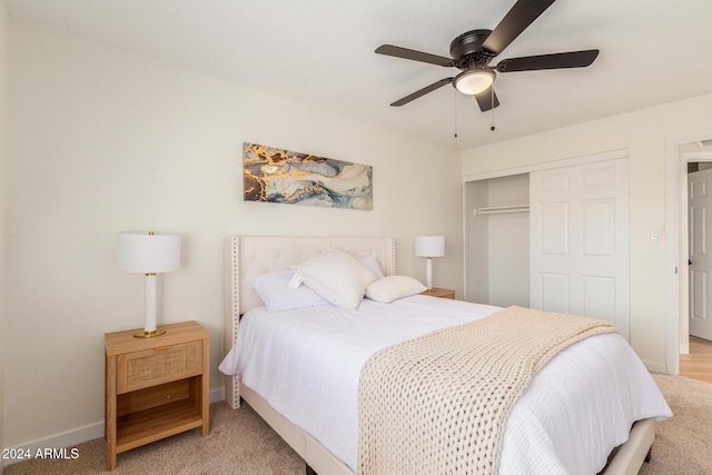 bedroom with ceiling fan, baseboards, and a closet