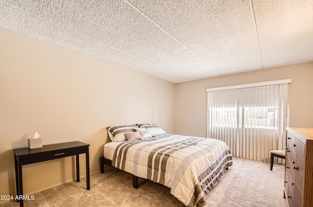 bedroom featuring carpet and a textured ceiling