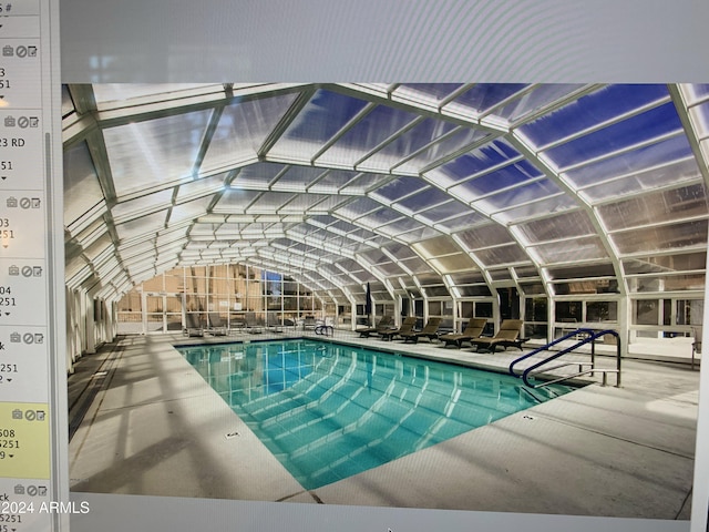 view of swimming pool with a lanai and a patio