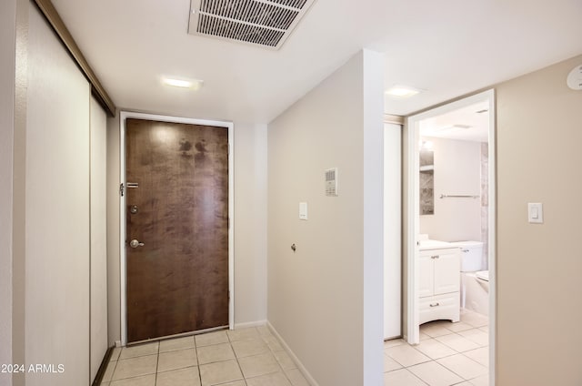 corridor featuring light tile patterned floors