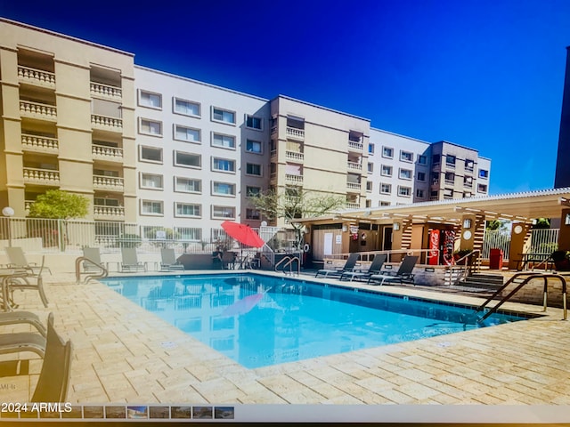 view of swimming pool with a patio