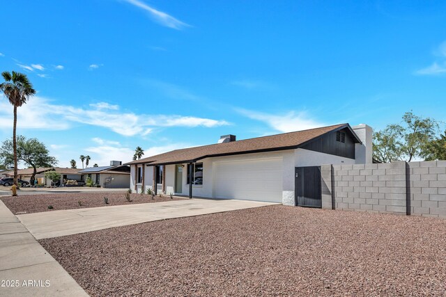 3614 W Danbury Dr, Glendale, AZ 85308 - view of front of house featuring a garage, driveway, and a chimney