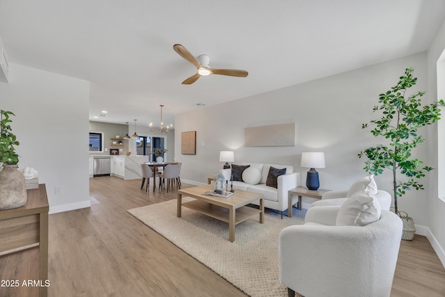 3614 W Danbury Dr, Glendale, AZ 85308 - living area with light wood-style floors, ceiling fan, and a chandelier