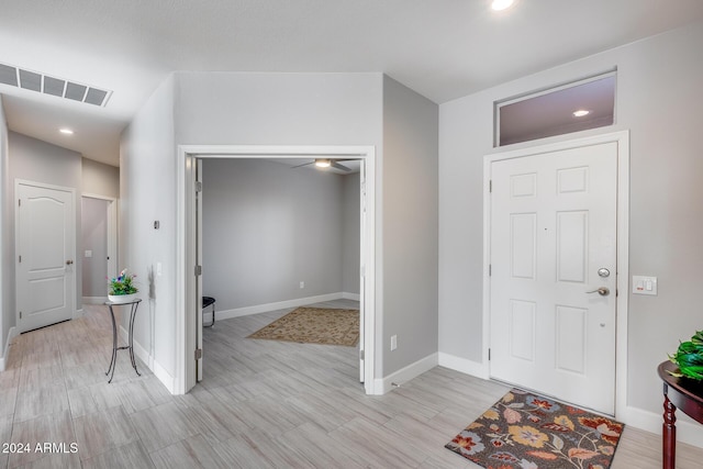 foyer entrance featuring light wood-type flooring and ceiling fan