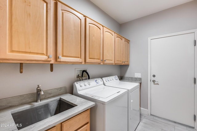 laundry room with sink, cabinets, and independent washer and dryer