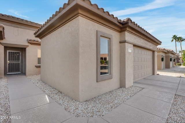 view of side of home featuring a garage