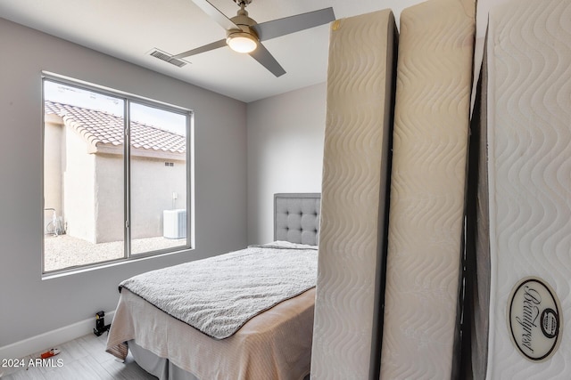 bedroom featuring ceiling fan and multiple windows