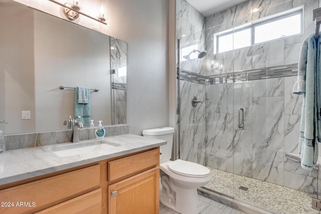 bathroom featuring vanity, toilet, and an enclosed shower