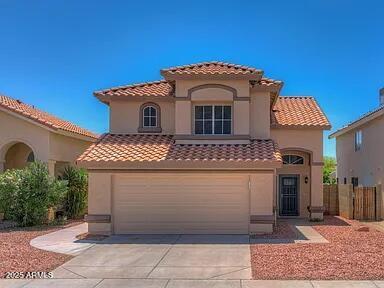 mediterranean / spanish-style house with a garage