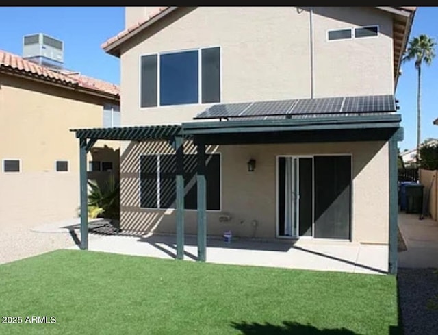 back of property featuring a lawn, central AC unit, a patio area, and a pergola