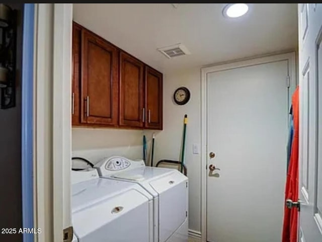 washroom featuring cabinets and independent washer and dryer