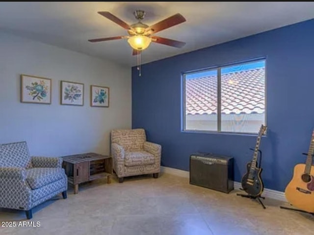 sitting room featuring ceiling fan