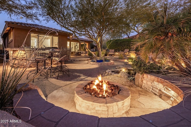 view of patio / terrace featuring an outdoor fire pit