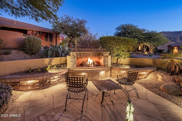 view of patio / terrace featuring an outdoor stone fireplace