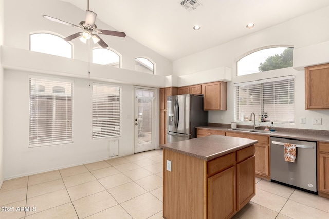 kitchen featuring visible vents, light tile patterned floors, appliances with stainless steel finishes, a ceiling fan, and a sink