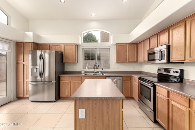 kitchen featuring a sink, a kitchen island, recessed lighting, appliances with stainless steel finishes, and light tile patterned floors