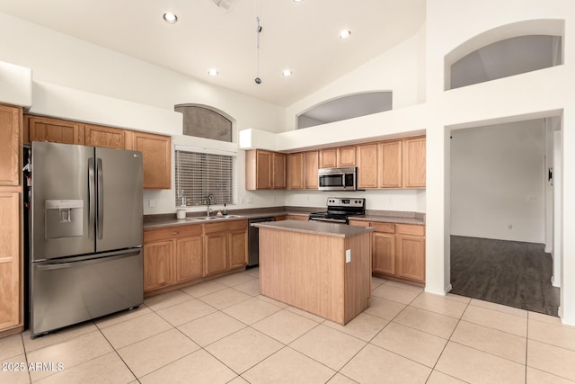 kitchen featuring high vaulted ceiling, a sink, a kitchen island, appliances with stainless steel finishes, and light tile patterned floors