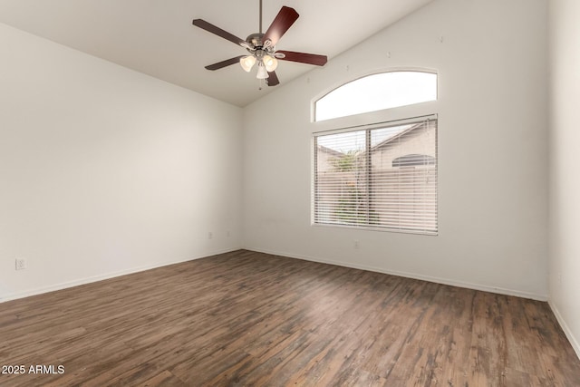 spare room with vaulted ceiling, wood finished floors, baseboards, and ceiling fan