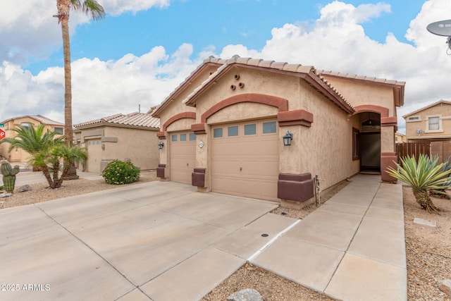 mediterranean / spanish house featuring stucco siding, driveway, and an attached garage