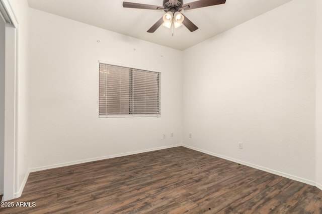 spare room with dark wood finished floors, baseboards, and ceiling fan