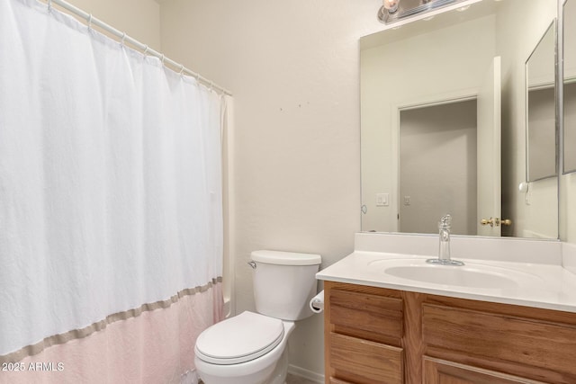 full bathroom with toilet and vanity