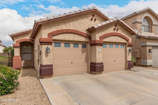 view of front of house featuring concrete driveway, a garage, and stucco siding