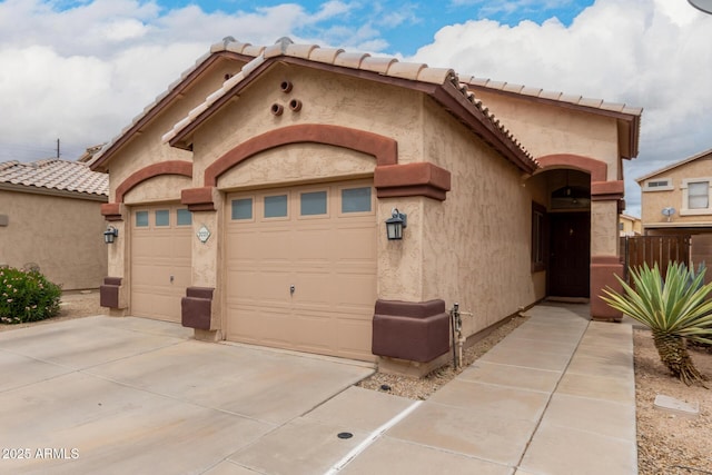 view of front of property featuring stucco siding, an attached garage, and driveway