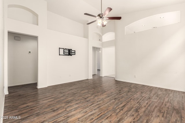 spare room featuring dark wood finished floors, a ceiling fan, and high vaulted ceiling