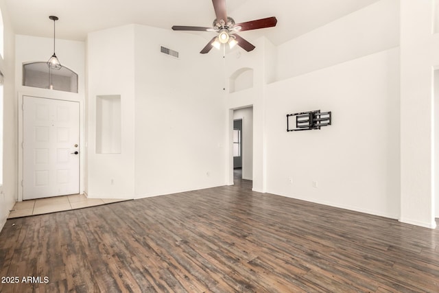 spare room featuring a ceiling fan, wood finished floors, visible vents, and high vaulted ceiling