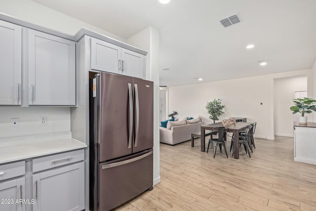 kitchen featuring gray cabinets, stainless steel refrigerator, and light hardwood / wood-style flooring