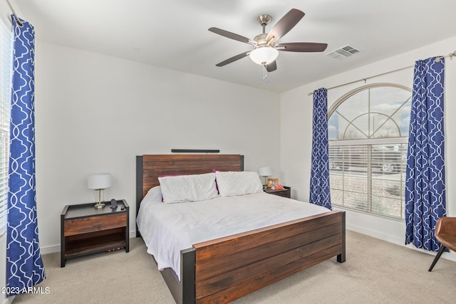 bedroom featuring light carpet and ceiling fan