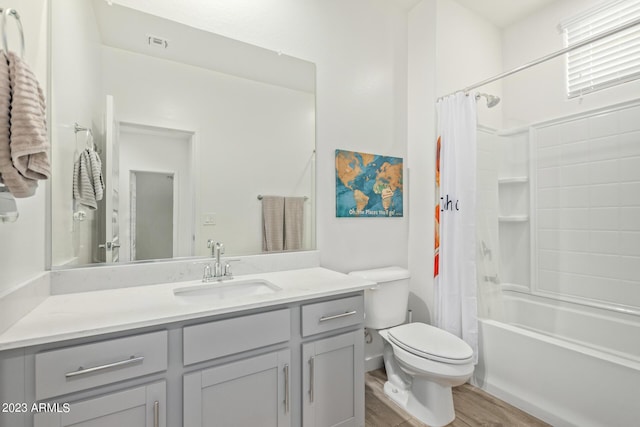 full bathroom featuring vanity, hardwood / wood-style flooring, toilet, and shower / tub combo with curtain