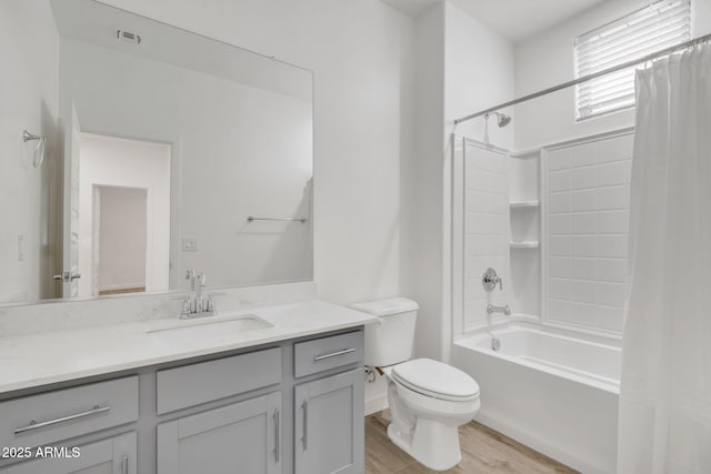 full bathroom featuring vanity, toilet, hardwood / wood-style floors, and shower / bath combo