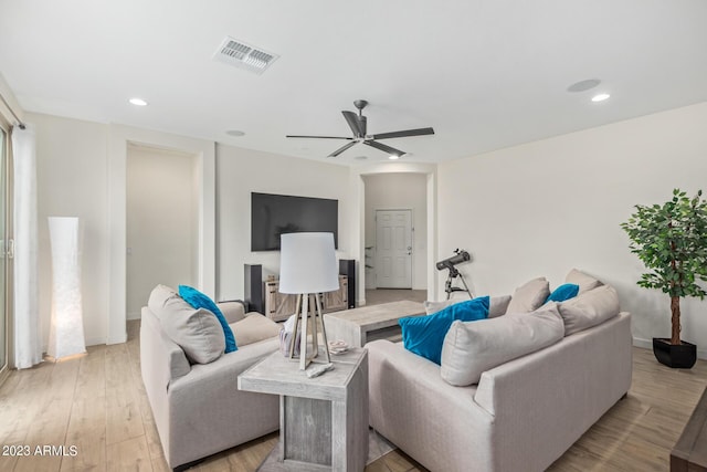 living room featuring ceiling fan and light wood-type flooring